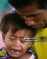 Grandfater of Kristian Walker, Daniel poses with a photo of his... News  Photo