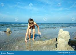 Boy playing on the beach stock photo. Image of coast, water - 1286682