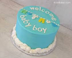 This buttercream iced baby shower cake has a neutral theme with pretty shades of green and vintage pink. Welcome Baby Boy Clothes Line Baby Shower Cake