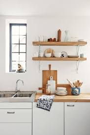 Simple Unstained Oak Wood Floating Shelves On White Painted Wall With Metal Bracket And Flat Kitchen Shelf Design Wall Mounted Kitchen Shelves Kitchen Interior