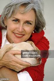 Portrait Of Mature Woman Hugging Her Poodle High-Res Stock Photo