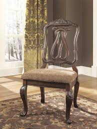 A choice blend of materials is accented by the most intricate appliques. North Shore Dining Table D553 35 Dark Brown By Ashley Furniture