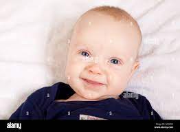 Smiling Three Month Old Newborn Baby Boy With Cute Friendly Innocent Facial Expression And Big Blue Eyes Stock Photo Alamy
