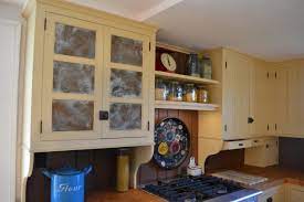 Punched tin, one of the old fashioned early american looks might be the answer that you are looking for. Custom Cabinetry Shenandoah Restorations
