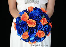 A bright wedding bouquet with blue, orange and peachy blooms and much texture. Flower Colors Orange Wedding Flowers Orange Wedding Blue Orange Weddings