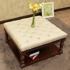 A tufted ottoman makes a more comfortable footrest. Cairona Fabric 30 Inch Tufted Shelved Ottoman Overstock 13681209