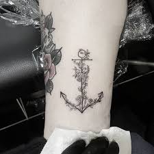 The anchor has religious significance with evidence of representations from early christianity found in ancient catacombs. Small Anchor Tattoo With Flowers