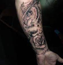 Traditional colorful owl with clock and rose tattoo on left thigh. Facebook