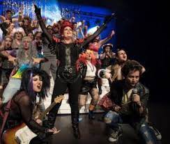 The character's name is a reference to the lyrics in the queen song bohemian rhapsody. We Will Rock You Rocks Stage Whispers