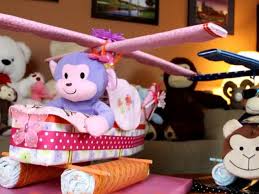 Diaper cakes act as cute baby shower decor and also make the perfect shower gift! How To Make A Helicopter Diaper Cake With Easy To Follow Video Instructions