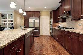 The warmth of the orange accents is tempered by the cool blue and brick tones. Will A Dark Color Scheme Work For Your Kitchen