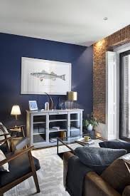 Loft Inspired Living Room With Exposed Brick Wall And Blue Accents Nonagon Style Blue Walls Living Room Brick Living Room Brick Wall Living Room