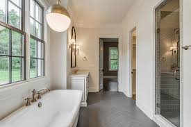 Large herringbone floors add impact to your space. White Bathroom With Dark Gray Herringbone Tile Floor Transitional Bathroom