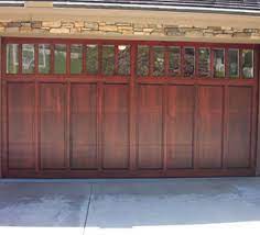 Proper staining is an important maintenance to keep your garage door protected from the elements and save home owners the cost of replacement in the long run. Wood Garage Doors Omaha Door Window