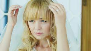 ▪ wavy (=with loose curls) her golden wavy hair fell around her shoulders. Young Attractive Bride Looks In Stock Footage Video 100 Royalty Free 14034401 Shutterstock