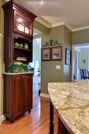 Maintaining the white color on the cabinets and walls (the perimeter of the kitchen) and popping in some steel elements in appliances helps to keep the star of the kitchen the coral center island. What Color Paint To Tone Down The Cherry Cabinets