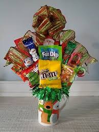 All you need is a mason jar, shredded color paper, wooden sticks, ribbon, and decorative flowers from the craft section. Home Garden Christmas Gift Basket Elf Candy Bouquet Chocolate Arrangement Santa Clause Greeting Cards Party Supply