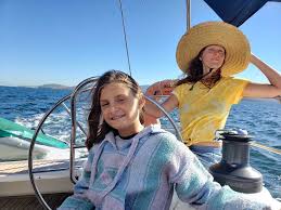 Mother and daughter enjoying sailing adventure on yacht deck with mountains in background - family-friendly Sea of Cortez sailing experience in Baja California