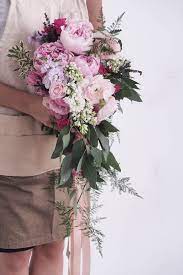 Brides cascade bouquet with roses & mini callas. Pink Peonies Cascading Waterfall Bouquet With Lavender Stock Syringa Eucalyptus Leaves By Flora Cascading Bridal Bouquets Bridal Bouquet Peonies Bridal Flowers