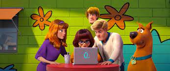 In Scoob! (2020) having run out of mysteries to solve Velma comes up with  the idea to create one of their own on the internet. Posting anonymously on  4chan under the username 