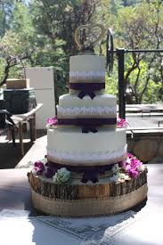 Full View Of Country Inspired Wedding Cake On Wood Slab Base Burlap Lace And Ribbon Cool Wedding Cakes Country Wedding Cakes Wedding Cakes