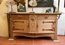 At centre is a beveled mirror, with a green marble tabletop below and beveled glass doors above. Art Nouveau Sideboard In Lightened Oak Buffets