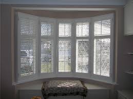 The muted grey tones in this bedroom look extremely luxurious and create a classic the period feature fireplace contrasts this and the bay window shutters complete the look. Made To Measure Shutters Hannan Blinds Shutters Preston
