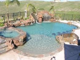 Waterfall Slide Grotto And Sunken Bar Backyard Pool Landscaping Backyard Pool Pool Landscaping