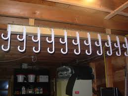 Garage door storage rack to store fishing rods, kayak paddles, & most light garden tools. Fishing Pole Storage Fishing Rod Storage Fishing Umbrella