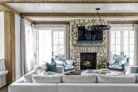 Bold home exterior with stone chimney and black details. 10 Fireplace Designs We Love Douglas Vanderhorn Architects
