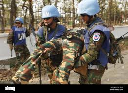 U.N. Peacekeepers from the Royal Cambodian Armed Forces evacuate a  simulated rebel casualty during a simulated firefight as part of a field  training exercise