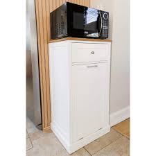 This one is integrated into the countertop so you can easily just slide the trash in as you're prepping food. Spacemaster Microwave Kitchen Cart With Hideaway Trash Can Holder And Spacemaster