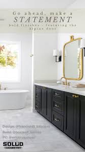 Black And Gold Bathroom Vanity A Bathroom Vanity With Black Cabinets Gold Hardware And A Soaking Bathtub Featuring The Alpin Custom Bathroom Custom Bathroom Vanity Custom Kitchen Cabinets