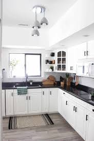 Though this kitchen's range and cabinets are both white, one has brass hardware, while the other has silver. Our Weekend Renovation A New Modern Kitchen Love Create Celebrate Black Kitchen Countertops Modern Black Kitchen Modern Kitchen Design