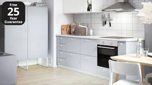 White cabinets showing against walnut doors. Veddinge Grey Kitchen Ikea