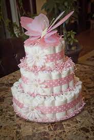 Packed inside the layers of diapers, are baby and nursery essentials to help mama get started. Baby Girl Diaper Cake Baby Girl Shower Pink Baby Shower Diy Diaper Cakes Girl