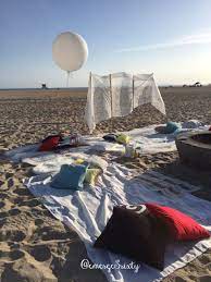 Birthday Huntington Beach Bonfire Party White Lace Backdrop Big Balloon Decorative Pillows Lanterns Rugs Beach Bonfire Parties Bonfire Party Beach Bonfire