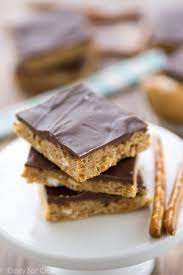 With a tablespoon, spoon the peanut butter and the strawberry jam all over the cookie dough. Trisha Yearwood Inspired Chocolate Peanut Butter Bars Thebestdessertrecipes Com