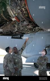 Air Force Master Sgt. Eric Martin (left), Tech. Sgt. Kyle Kikuchi (center)  and Staff Sgt. Joel Fernandez (right), level a downlink antenna, Clark Air  Base, Philippines, Jan. 15, 2017. Martin, Kikuchi and