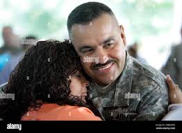 National Guard Sgt. 1st Class Edwin Pena, right, hold his wife Bruny Pena  as he arrives in Harrisburg, Pa.,