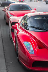 In a video posted to the web, the british rocker's new ride can be seen leaving a london dealership to be delivered to its new home. Hd Wallpaper Two Red Sports Cars On Asphalt Road Way Ferrari Enzo Transportation Wallpaper Flare