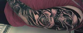 These two sides symbolize two facets of love: 50 Skull Sleeve Tattoos For Men Masculine Design Ideas