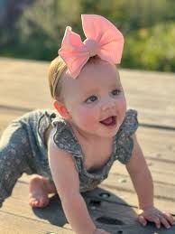 Admiring a baby's outfit and photo