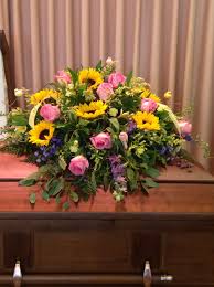 Full of beauty, radiance and happiness, nothing brightens their day quite like sunflowers. Pink Roses And Sunflowers In A Casket Spray Casket Flowers Sympathy Flowers Funeral Flower Arrangements