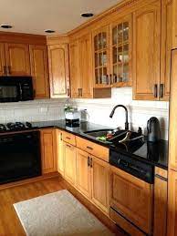 Honey Oak Cabinets With Black Countertop And Black Hardware Trendy Kitchen Tile Kitchen Tile Backsplash With Oak Cabinets And Countertops