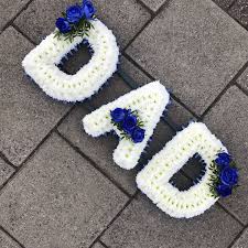 Maybe you would like to learn more about one of these? White Based Dad Funeral Flowers Tribute With Navy Ribbon Edge And Blue Rose Detail Dad Funeral Flowers Funeral Flowers Blue Rose