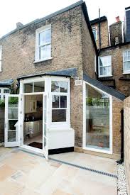 Lowering the floor and removing walls from the basement of a typical london terraced house created an extraordinary living space with a double height conservatory. House Extension Design Ideas Uk