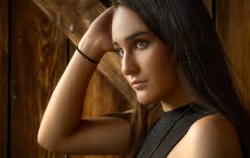 Young Woman Posing by a Window in Floral Dress