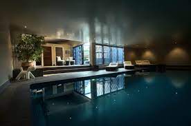 A retractable cover is located at the pool's far end. Basement Swimming Pools Compass Pools