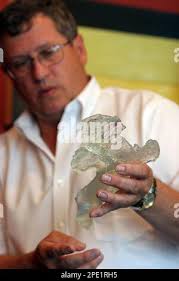 Dr. Doug Owsley, of the Smithsonian Institution's National Museum of  Natural History, explains a part of an exact model of the pelvis of  Kennewick Man, Sunday, July 2005, at University Towers in Seattle.  Scientists have began studying the 9,300-year-old ...